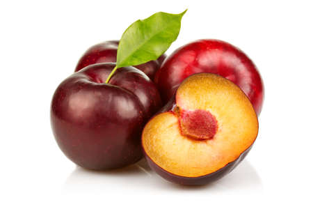 Ripe plums fruit with slices isolated on white backgroundの写真素材