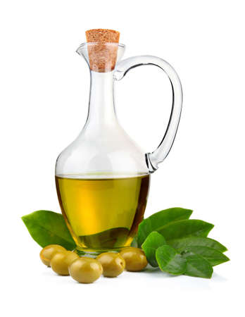 Bottle of olive oil and green leaves isolated on white backgroundの写真素材