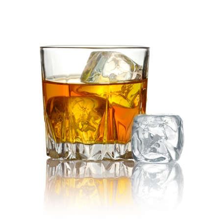 Glass of whiskey and ice isolated on white backgroundの写真素材