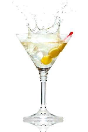 Olive splashing on martini glass isolated on white backgroundの写真素材