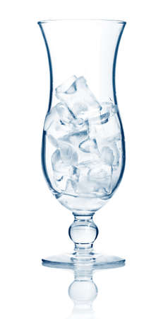 Highball cocktail glass full of ice cubes isolated on white backgroundの写真素材