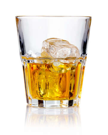 Whiskey glass with ice cubes and reflections isolated の写真素材