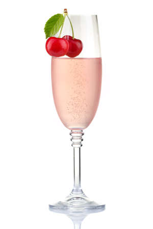 Glass of pink champagne with fresh cherry berries isolated on white backgroundの写真素材