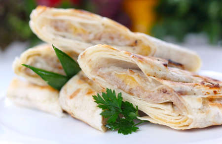 Roasted pancake with meat and greens (closeup, selective focus)の写真素材