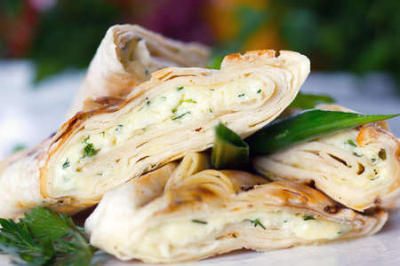 Roasted pancake with sheep cheese and greens (closeup, selective focus)の写真素材
