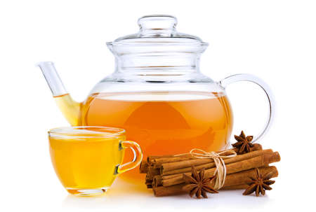 Cup and glass teapot with spices isolated on white background の写真素材