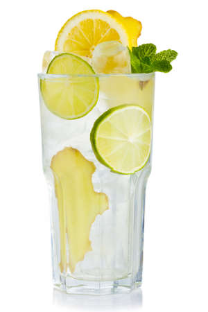 Full glass of fresh birch juice with lemon, ginger and mint leaves isolatedの写真素材