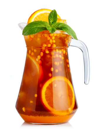 Full jug of nonalcoholic cocktail with orange fruits and sea-buckthorn isolated  の写真素材