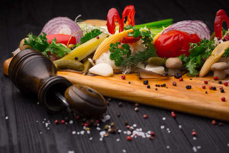Set of pickled vegetables on black wooden backgroundの写真素材