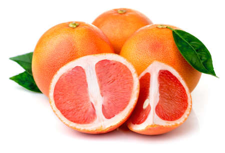 Pink grapefruits with green leaves isolated on white backgroundの写真素材