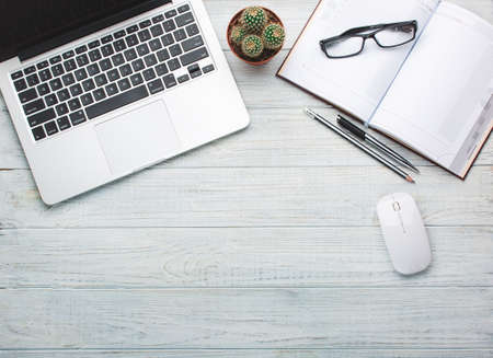 Modern workplace on wooden table with a lot of things on it. Top view.