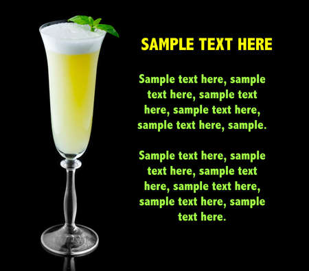 Yellow alcohol cocktail with fresh green basil isolated on black. Place for text.の写真素材