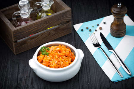 Stewed cabbage bigos on black rustic wooden backgroundの写真素材