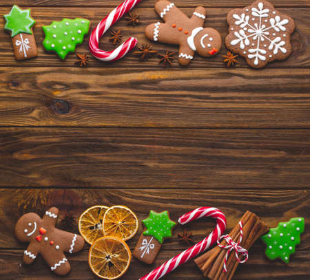 Christmas homemade gingerbread cookies on the wooden backgroundの写真素材