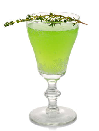 Green alcohol coctkail with spices isolated on white backgroundの写真素材
