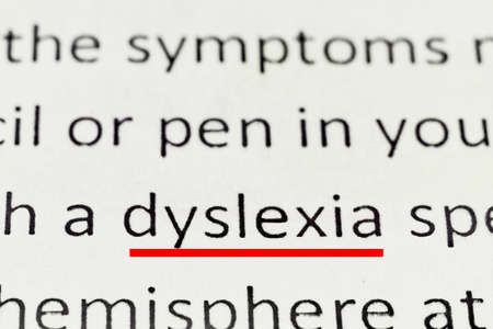 macro photography of the word dyslexia from the newspaper underlined in red markerの写真素材