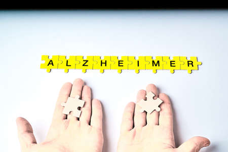 Alzheimer's disease, concept, the word Alzheimer is made up of puzzles in yellow with black letters...