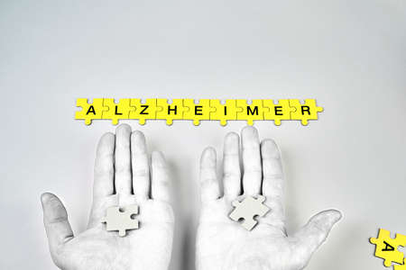 Alzheimer's disease, concept, the word Alzheimer is made up of puzzles in yellow with black letters...