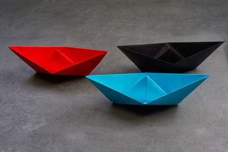 Business Concept, Paper Boat, the key opinion Leader, the concept of influence.Red.blue and black...