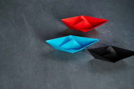 Business Concept, Paper Boat, the key opinion Leader, the concept of influence.Red.blue and black...