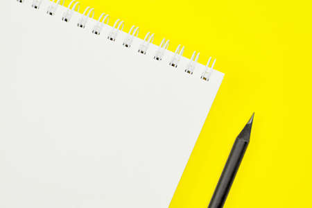 yellow office Desk top view with Notepad,and pencil,minimalistic design, top view,copy space,flat...