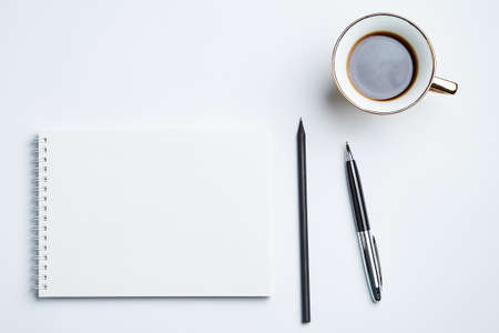 white office Desk top view with Notepad, pen, pencil and coffee Cup, minimalistic design, top view,copy space,flat layの写真素材