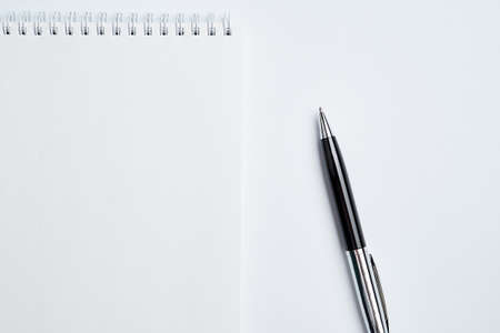 white office Desk top view with Notepad and pen,minimalistic design,top view,copy space,flat lay