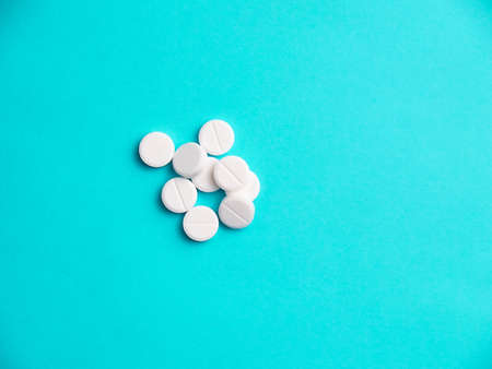 White pills on blue background copy spaceの写真素材