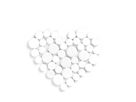 White medicine pills in the shape of a heart on a white background top view with copy space.の写真素材