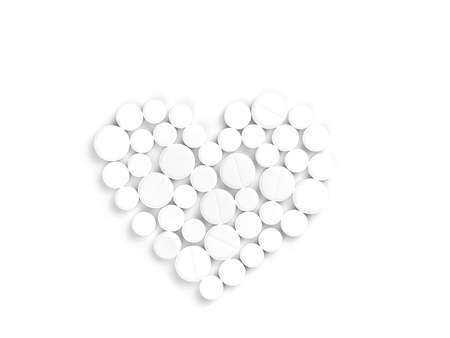 White medicine pills in the shape of a heart on a white background top view with copy space.の写真素材