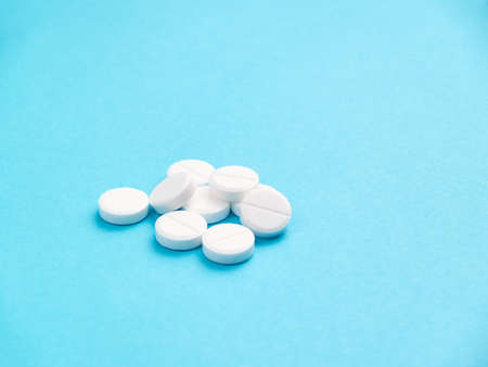 White pills on blue background copy spaceの写真素材