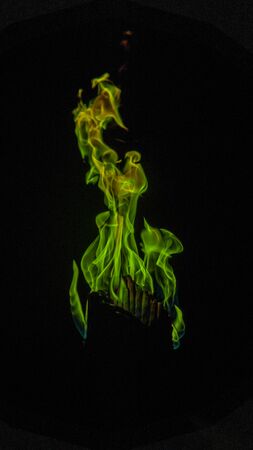 Green flame with black background