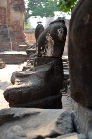 the ruins of Buddha sculptures in Ayutthayaの写真素材