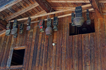 cowbell hanging under a roofの写真素材
