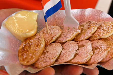 proffertjes with powdered sugar and butterの写真素材