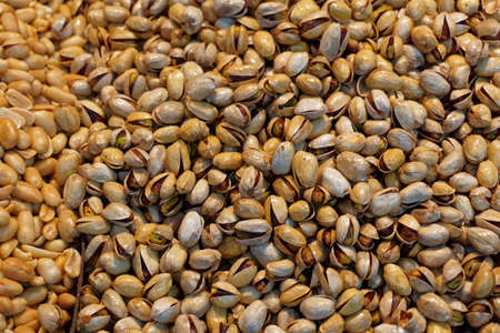 a heap of pistachios and peanutsの写真素材