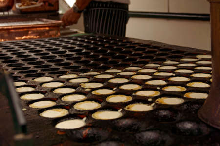 mini pancakes in a special pan on a market