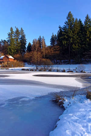 winter landscape with frozen lake on a sunny dayの写真素材