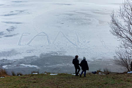 winter landscape with frozen lake and walkerの写真素材
