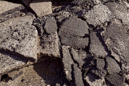 pice of broken asphalt, rocks backgroundの写真素材