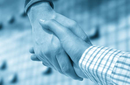Handshake of businessman against officeの写真素材