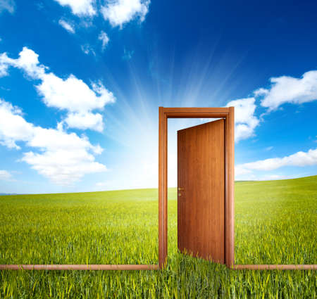 Home door open in a green clean fieldの写真素材