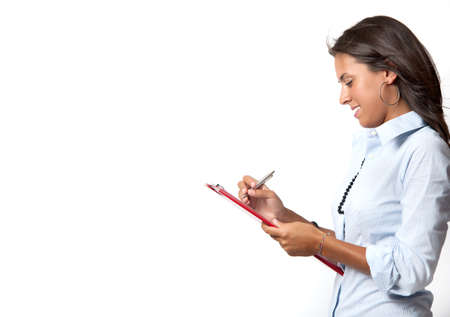Young businesswoman writing in a sheetの写真素材