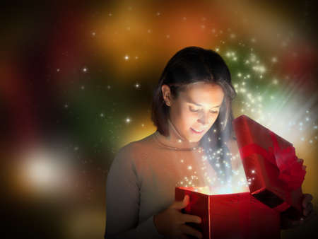 Magic Christmas present with surprised girlの写真素材