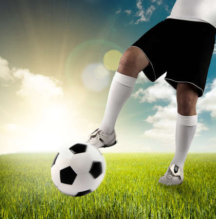 Player that plays football during sunriseの写真素材