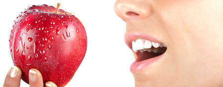 Youg woman with red appleの写真素材