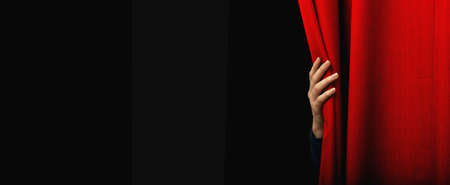 Girl open a red curtainの写真素材