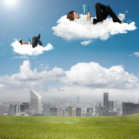 Business people reading book in the skyの写真素材