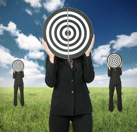 Business competition concept with businesswoman and darts boardの写真素材