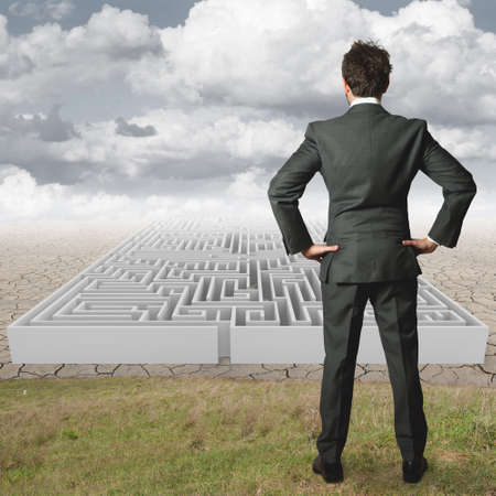 Businessman reflects on solving a mazeの写真素材